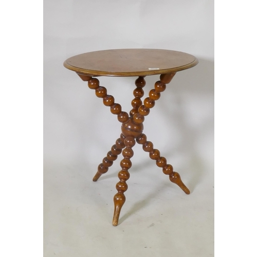 1108 - A C19th burr yew wood gypsy table, raised on crossed bobbin turned supports, 54cm diameter, 62cm hig... 