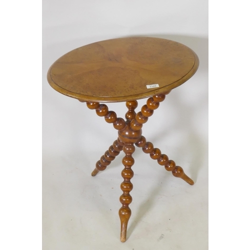 1108 - A C19th burr yew wood gypsy table, raised on crossed bobbin turned supports, 54cm diameter, 62cm hig... 