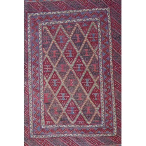 1098 - A Persian red ground wool rug with geometric bokhara style design, 126 x 180cm