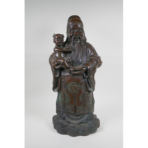 235 - A Chinese filled bronze figure of Fu, character mark to base, 55cm high