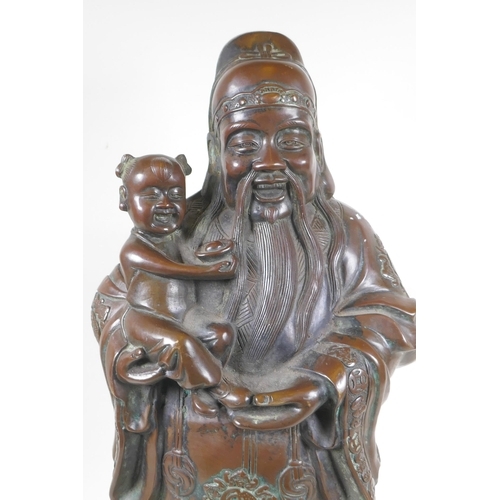 235 - A Chinese filled bronze figure of Fu, character mark to base, 55cm high