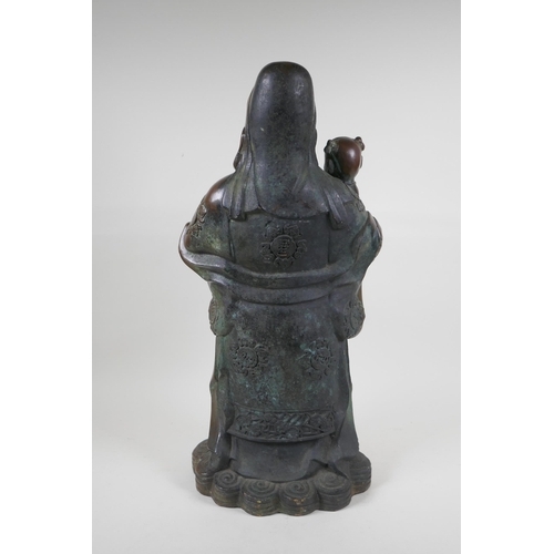 235 - A Chinese filled bronze figure of Fu, character mark to base, 55cm high