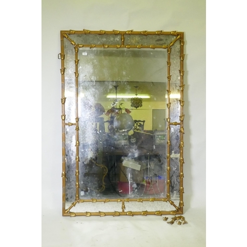 1062 - A gilt composition sectional wall mirror with central bevelled plate and antiqued glass border, AF, ... 