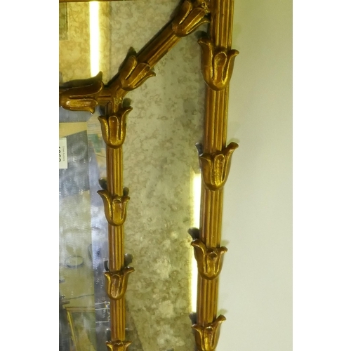 1062 - A gilt composition sectional wall mirror with central bevelled plate and antiqued glass border, AF, ... 