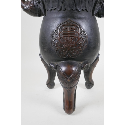 243 - A Chinese bronzed metal two handled censer and pierced cover, raised on elephant head tripod support... 