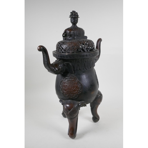 243 - A Chinese bronzed metal two handled censer and pierced cover, raised on elephant head tripod support... 