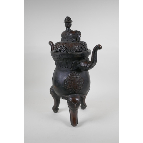 243 - A Chinese bronzed metal two handled censer and pierced cover, raised on elephant head tripod support... 