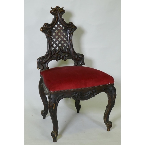 1048 - A C19th Chippendale style walnut hall chair, with carved and pierced trellis back, raised on cabriol... 