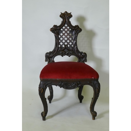 1048 - A C19th Chippendale style walnut hall chair, with carved and pierced trellis back, raised on cabriol... 