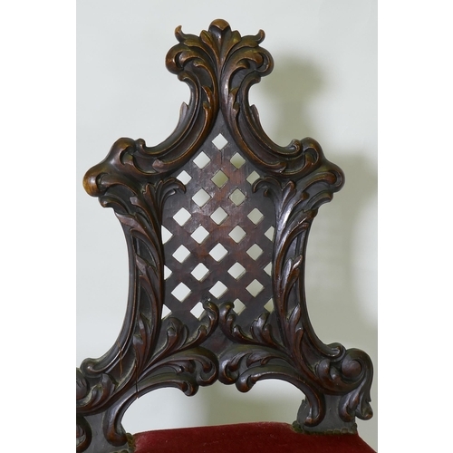 1048 - A C19th Chippendale style walnut hall chair, with carved and pierced trellis back, raised on cabriol... 