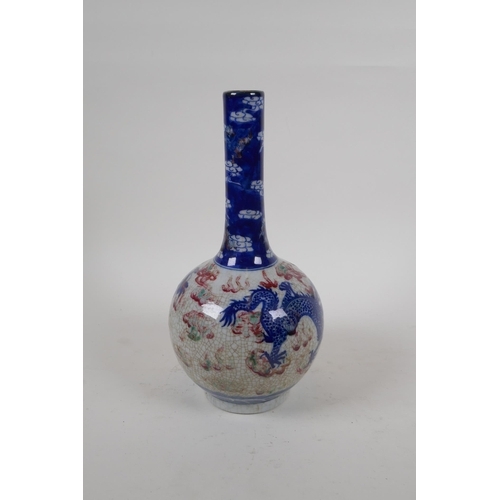 251 - A Chinese crackleware bottle vase with blue, white and red decoration of a dragon and phoenix in fli... 