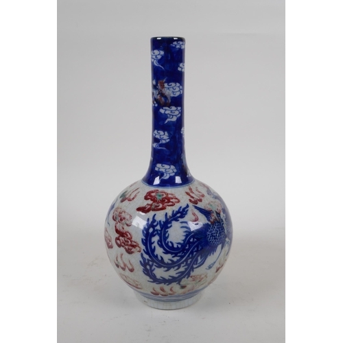 251 - A Chinese crackleware bottle vase with blue, white and red decoration of a dragon and phoenix in fli... 