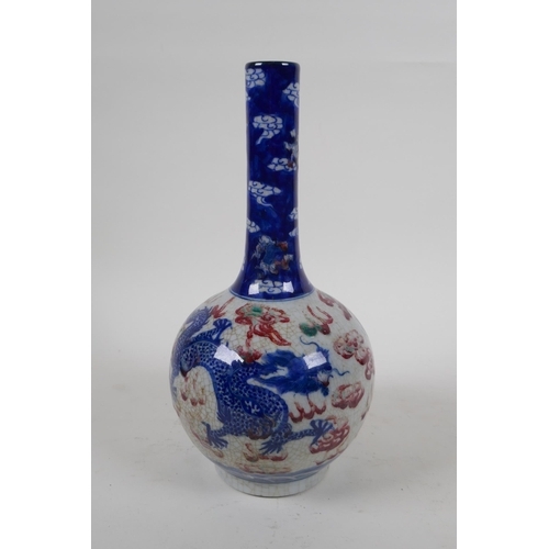 251 - A Chinese crackleware bottle vase with blue, white and red decoration of a dragon and phoenix in fli... 