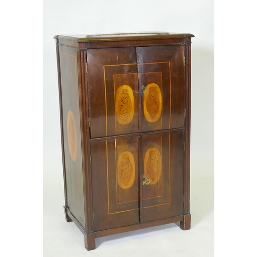 1043 - A C19th Continental mahogany four door cabinet with shell inlaid panels raised on block supports, 54... 