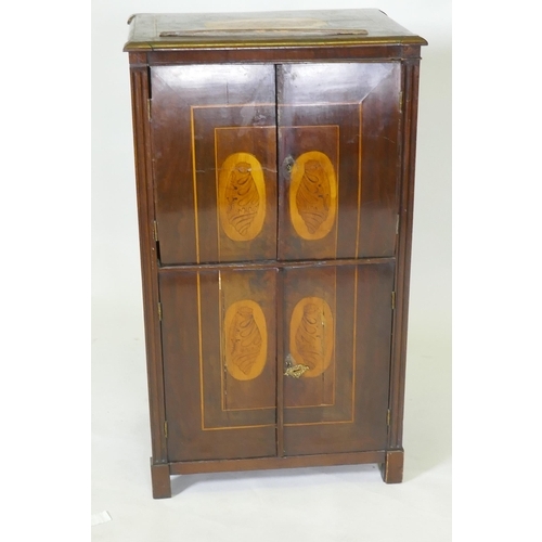 1043 - A C19th Continental mahogany four door cabinet with shell inlaid panels raised on block supports, 54... 