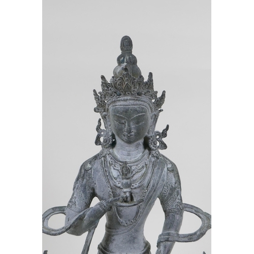 252 - A Sino Tibetan bronze figure of Buddha, with ver de gris patina, 33cm