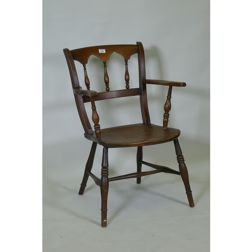 1022 - A C19th elm Oxford elbow chair with arched spindle back