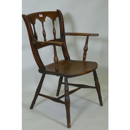 1022 - A C19th elm Oxford elbow chair with arched spindle back