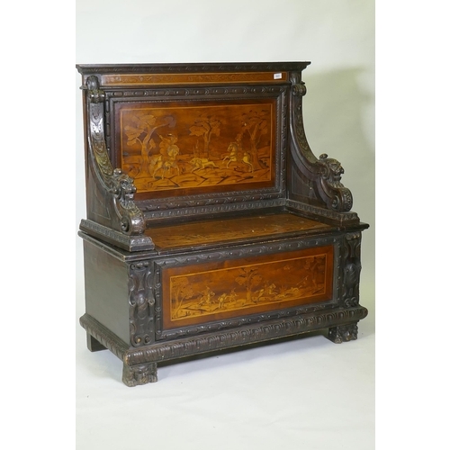 1021 - An early C19th Continental marquetry inlaid settle, the seat back and front panel decorated with hun... 