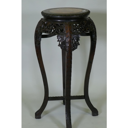 1017 - A tall Chinese hardwood jardiniere stand with shaped top inset with marble, with carved and pierced ... 