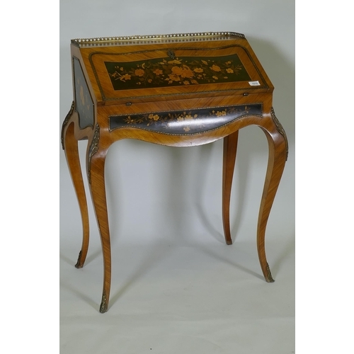 1015 - A French marquetry inlaid kingwood bureau-de-dame, with brass mounts, the fall front folding down to... 