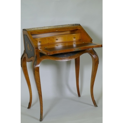 1015 - A French marquetry inlaid kingwood bureau-de-dame, with brass mounts, the fall front folding down to... 