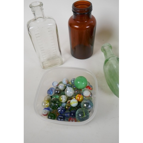 309 - A quantity of vintage glass bottles, stone ware pots and marbles, largest 23cm