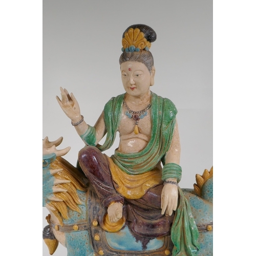 328 - A Chinese Sancai glazed pottery figure of an immortal riding a kylin, 47cm high