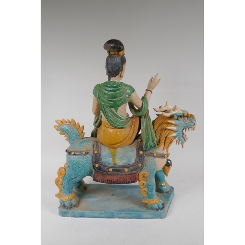 328 - A Chinese Sancai glazed pottery figure of an immortal riding a kylin, 47cm high