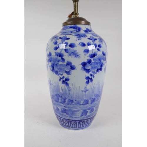 334 - A C19th Japanese blue and white porcelain vase decorated with a crane in a landscape, converted to a... 