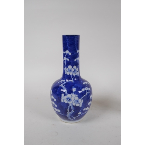 335 - A C19th Chinese blue and white bottle vase decorated with prunus blossom on a cracked ice ground, Ka... 