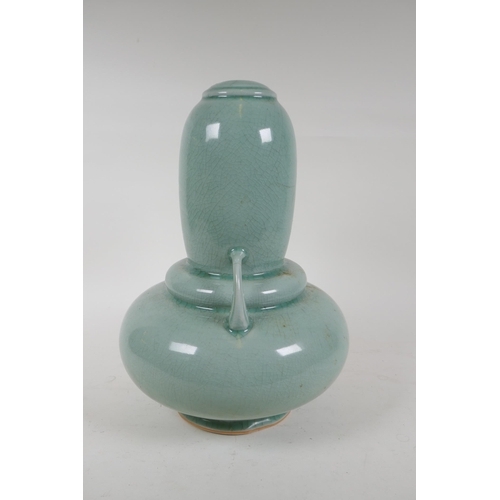 337 - An oriental celadon crackle glazed porcelain gourd with two handles, 34cm high, hairline cracks