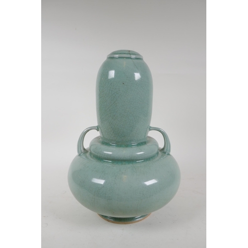 337 - An oriental celadon crackle glazed porcelain gourd with two handles, 34cm high, hairline cracks