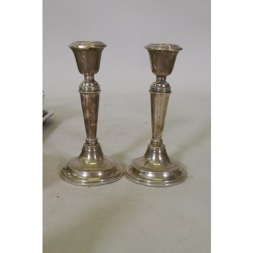 634 - A pair of hallmarked silver candlesticks, Elkington silver plated cocktail shaker, four piece tea se... 