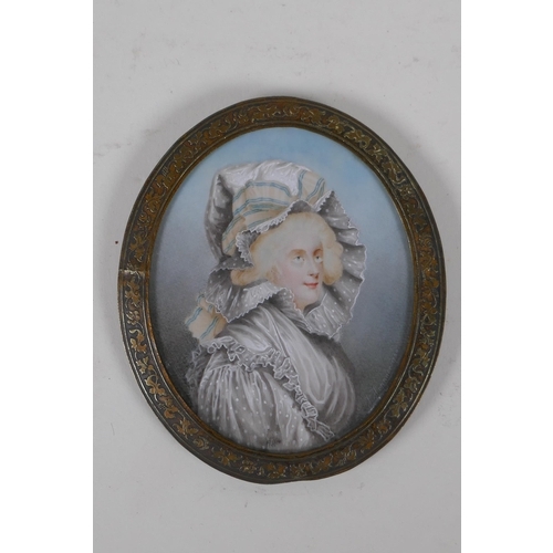 809 - An early C19th miniature watercolour portrait of a lady in a rose metal pendant frame, with plaited ... 