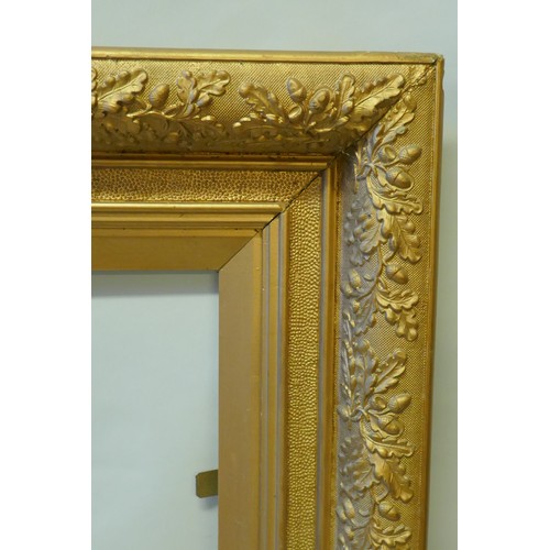 868 - A C19th giltwood and composition picture frame with oak and acorn moulded decoration, 50 x 81.5cm