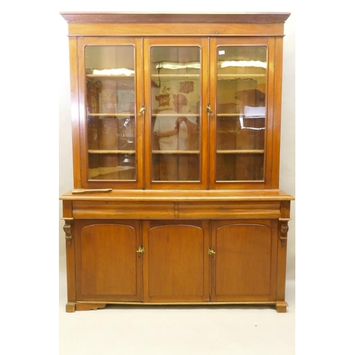 1130 - A C19th French stained fruitwood and walnut bookcase, the upper section with two glazed doors, fitte... 