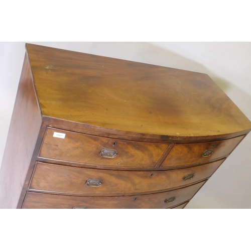 1121 - A Georgian mahogany bowfront chest of two over three drawers with cock beaded detail and brass plate... 