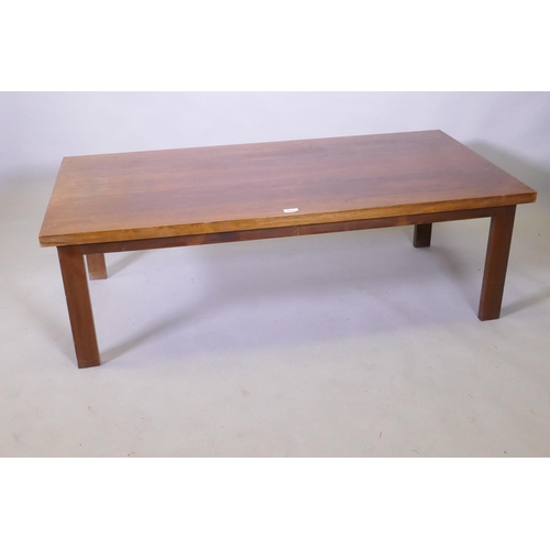 1123 - A mid century rosewood coffee table raised on square supports, 70 x 138 x 45cm