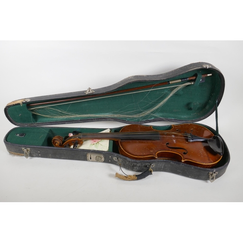 302 - A violin and bow, the neck of the violin stamped RMB 1206, in a carry case, violin 59cm long