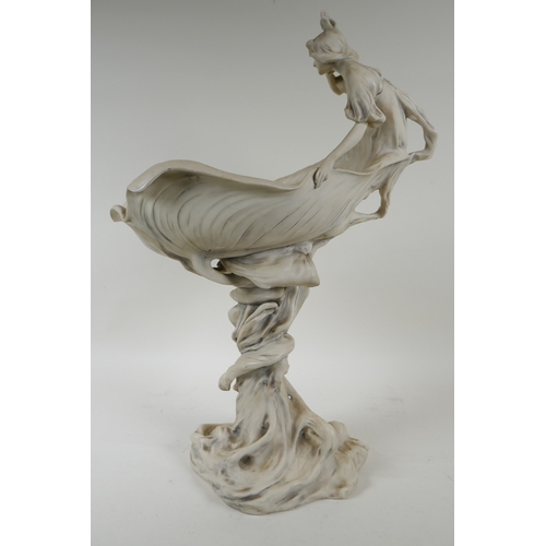 1 - A Royal Dux porcelain Art Nouveau centrepiece depicting a nymph sitting on a leaf shaped bowl, the p... 