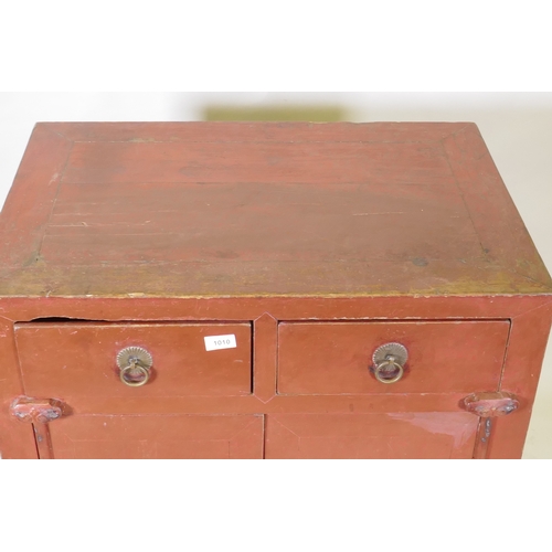 1010 - A Chinese red lacquered wood cabinet with two drawers over two doors, 74 x 50cm, 87cm high