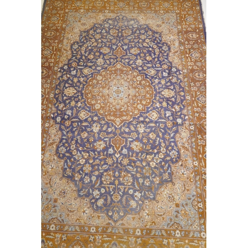 1011 - Antique Persian carpet with medallion design on blue field with terracotta borders and all over foli... 