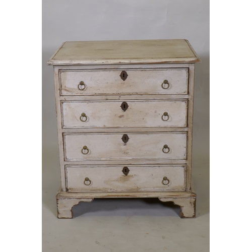 1014 - A painted pine chest of four long drawers with brass ring handles, raised on bracket supports, 61 x ... 