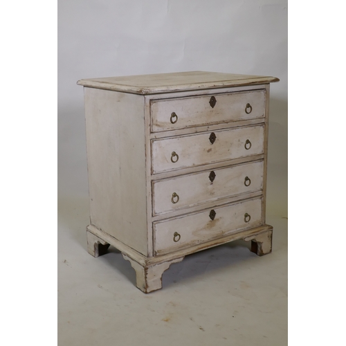 1014 - A painted pine chest of four long drawers with brass ring handles, raised on bracket supports, 61 x ... 