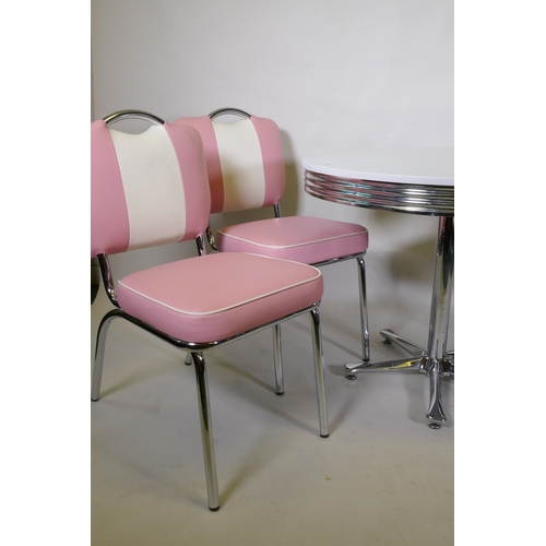 1016 - An American vintage style table and four chairs with chrome frames and vinyl covers, table 90cm diam... 