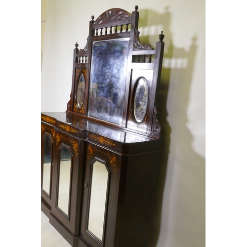 1018 - A Victorian walnut mirror backed chiffonier with breakfront base and three glazed doors, 115 x 30 x ... 