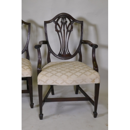 1040 - A set of eight (six plus two) Hepplewhite style shield back chairs, with over stuffed serpentine fro... 