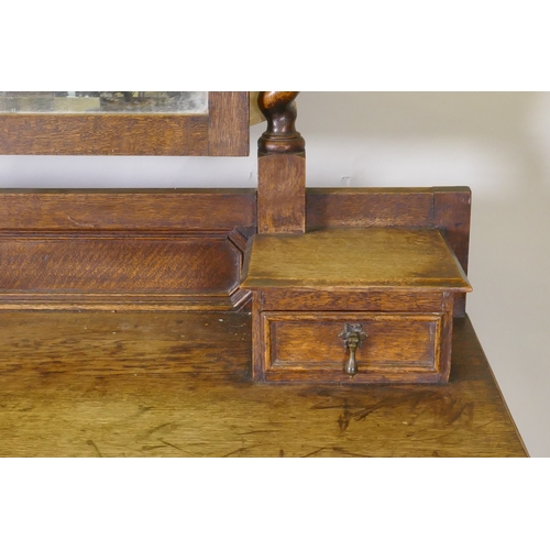 1041 - An early C20th oak Jacobean style dressing table, with swing mirror supported by barley twist column... 