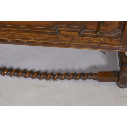 1041 - An early C20th oak Jacobean style dressing table, with swing mirror supported by barley twist column... 